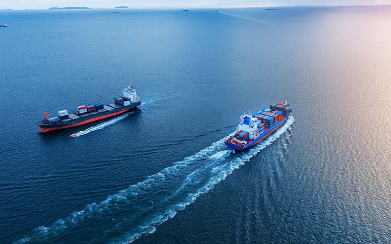 Two cargo ships exporting goods from the United States, benefiting from tax incentives for exporters.