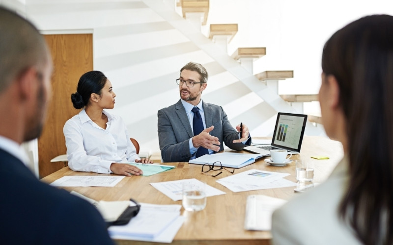 Business leaders discussing reinvestment of IC-DISC producer’s loan into core operations