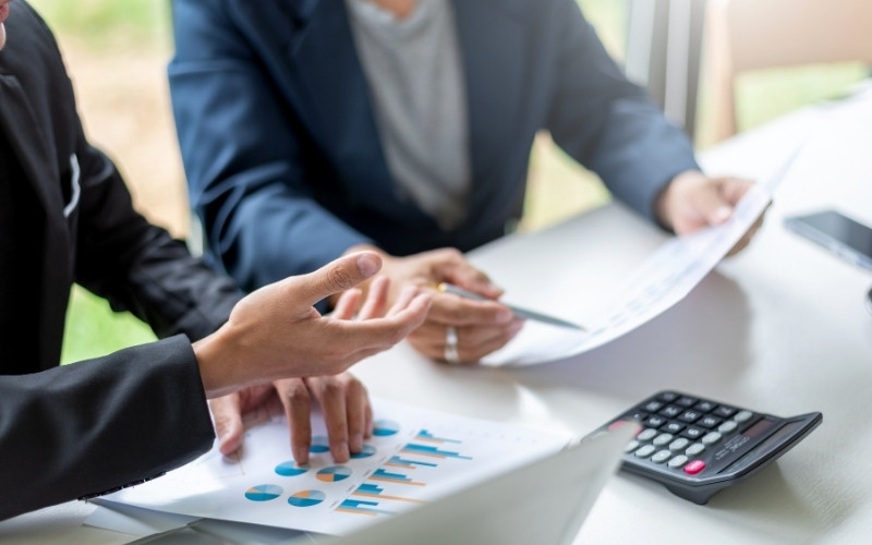 Tax professionals reviewing financial reports for accurate 1120-IC-DISC Schedule K compliance