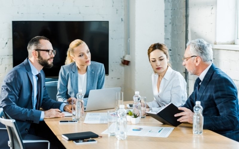 Team discussing IC-DISC Schedule K to report deferred income for export tax compliance