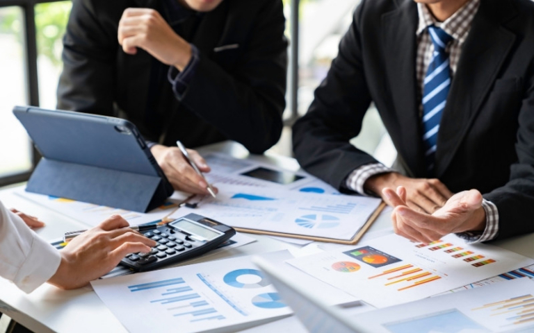Business professionals reviewing financial data for interest apportionment and IC-DISC compliance.