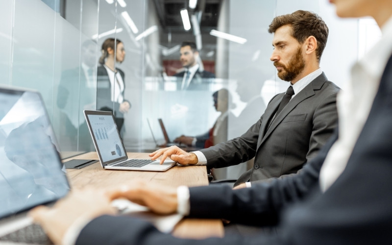 Professionals reviewing technology and data controls for IC-DISC risk management